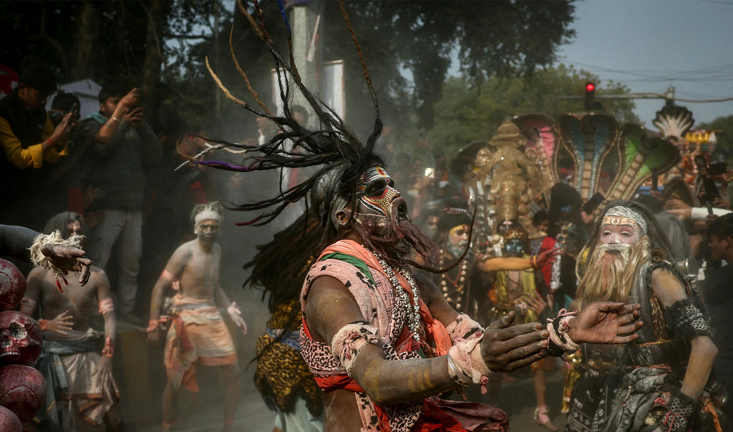 Hindu devotees smeared with ash dance during a religious procession ahead of the Maha Kumbh Mela festival in Prayagraj on January 10, 2025. (REUTERS)
