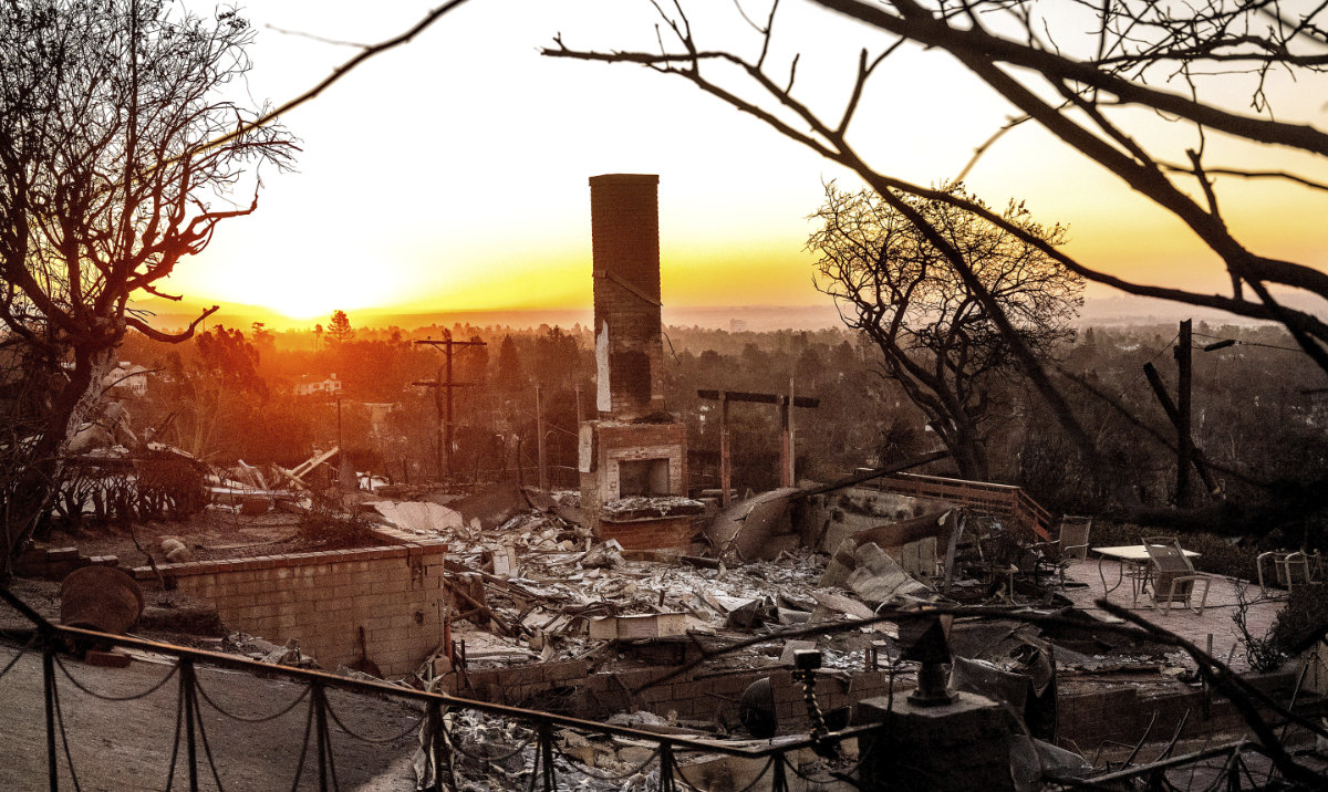 The sun rises behind a home destroyed by the Palisades Fire in the Pacific Palisades community of Los Angeles on Sunday, Jan. 12, 2025. (AP)
