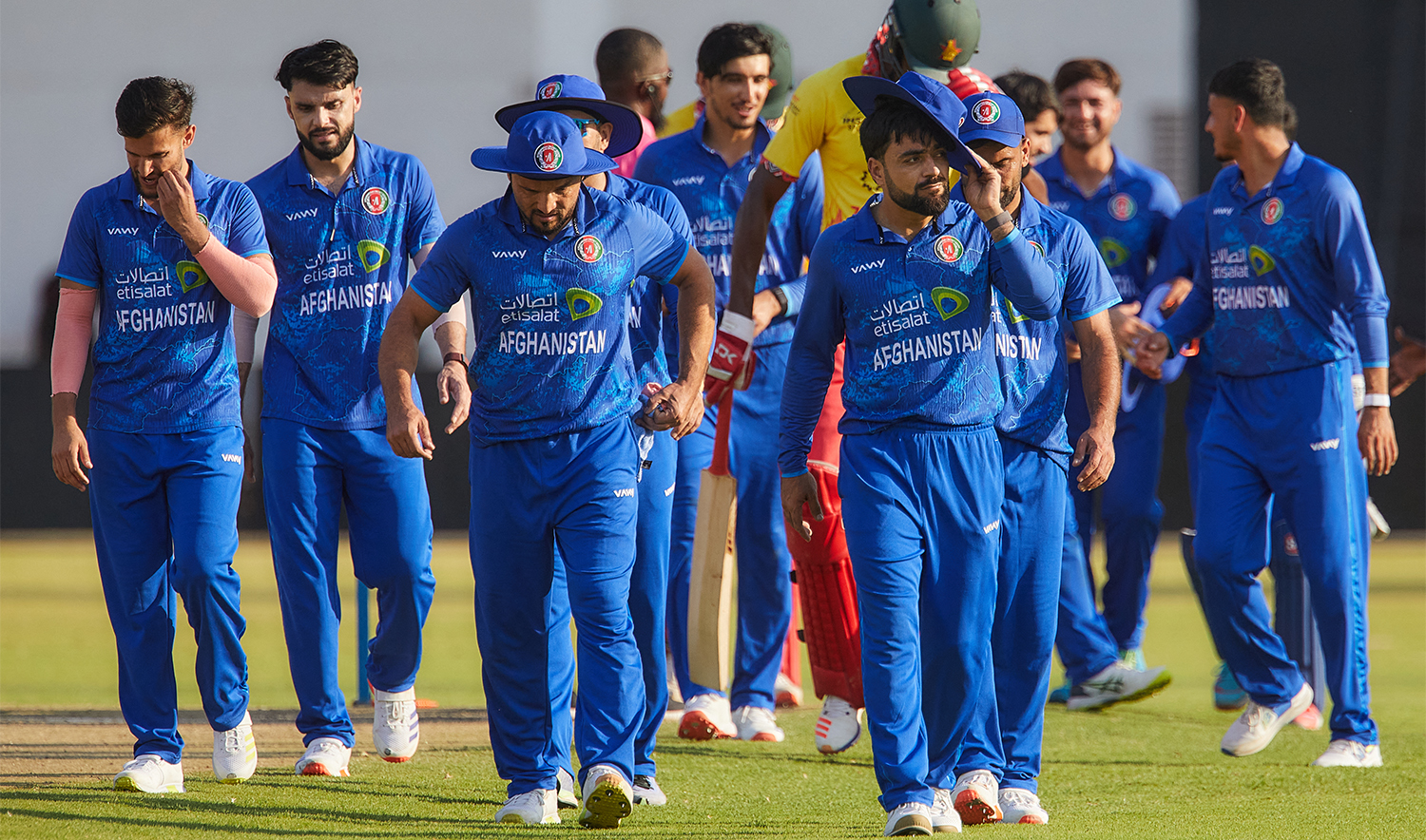 Afghanistan players walk off the field afer their victory during the second T20 international cricket match between Zimbabwe and Afghanistan at the Harare Sports Club in Harare on December 13, 2024. (AFP/File)