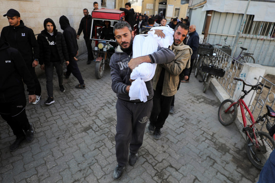 Men carry the body of a Palestinian killed in Israeli strikes, amid the ongoing conflict between Israel and Hamas, at Al-Ahli Arab Baptist Hospital in Gaza City, January 13, 2025. (Reuters)