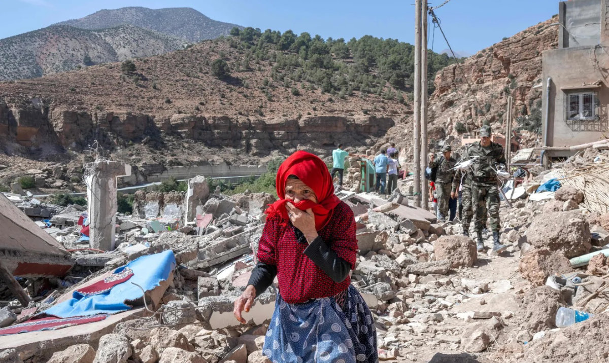 A woman walks amid debris in the earthquake-hit village of Imi N'Tala on September 19, 2023. (AFP)