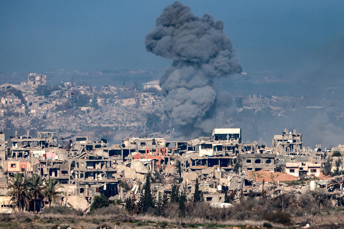 This picture taken from the Israeli side of the border with the Gaza Strip shows a smoke plume rising from explosions above destroyed buildings in the northern Gaza Strip on January 13, 2025 amid the ongoing war between Israel and Hamas. (AFP)