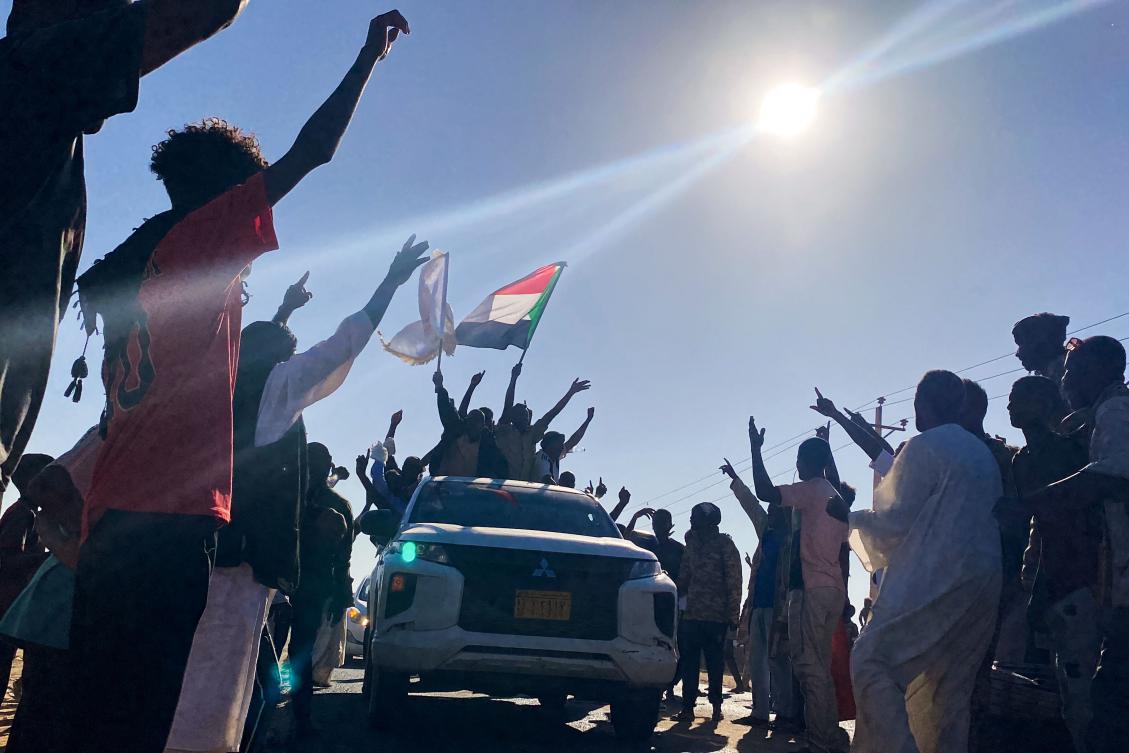 Sudanese people celebrate with passengers of passing vehicles in Meroe in the country’s Northern State on January 11, 2025, after the army announced entering key Al-Jazira state capital Wad Madani, held by the paramilitary Rapid Support Forces (RSF). (AFP)