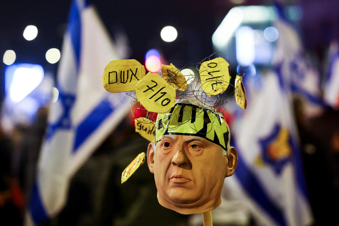 A mask depicting Israeli Prime Minister Benjamin Netanyahu is placed on a stick, at protest against the government, January 11, 2025. (REUTERS)