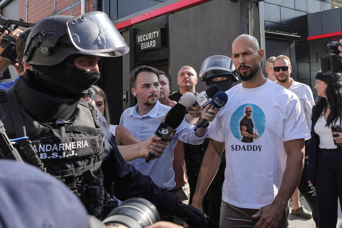 Romanian Gendarmes from the Special Intervention Brigade escort Andrew Tate outside the Tate brothers residence in Pipera, Ilfov, near Bucharest, Aug. 21, 2024. (Reuters/File)