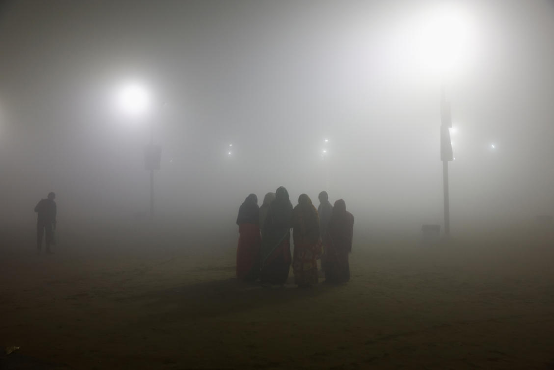 Devotees stand on the banks of river Ganga during the “Maha Kumbh Mela,” or the Great Pitcher Festival on a foggy evening in Prayagraj, India, January 14, 2025. (REUTERS)
