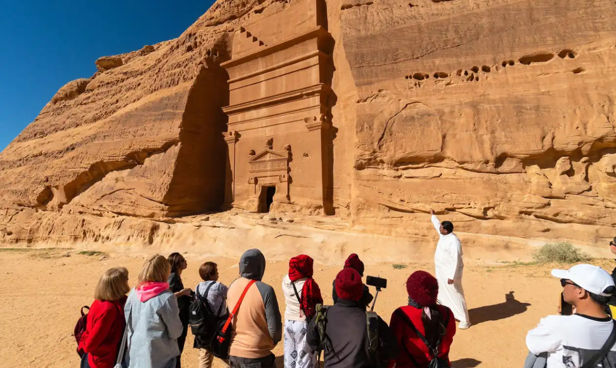 Tourists visit the tombs of the Nabatean civilization in AlUla. (Reuters)