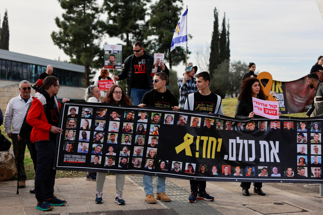 Families and supporters of Israeli hostages kidnapped during the deadly Oct. 7 attack by Hamas, hold a banner as they gather to demand a deal that will bring back all the hostages held in Gaza, outside a meeting between hostage representatives and Israeli PM Benjamin Netanyahu, Jan. 14, 2025. (Reuters)