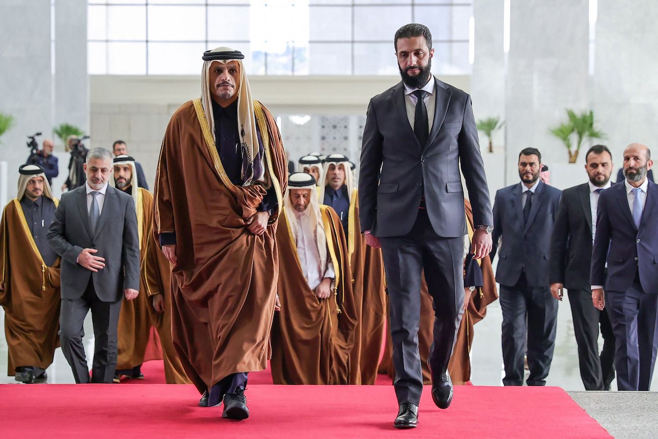 Syria’s new leader Ahmed Al-Sharaa welcomes Qatari Prime Minister Sheikh Mohammed bin Abdulrahman bin Jassim Al-Thani in Damascus on January 16, 2025. (AFP)