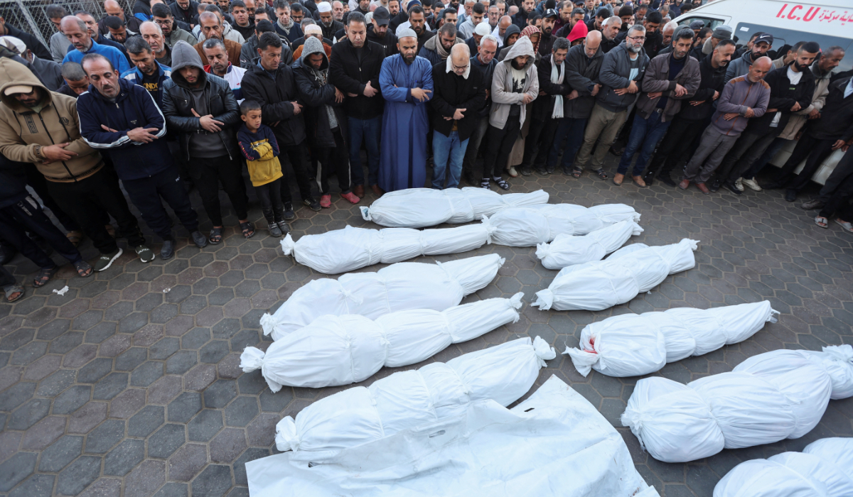 Mourners perform funeral prayers near the bodies of Palestinians killed in Israeli strikes, amid the ongoing conflict between Israel and Hamas, at Al-Aqsa Martyrs hospital, in Deir Al-Balah in the central Gaza Strip, January 15, 2025. (REUTERS)