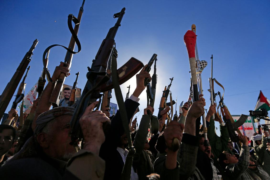 Demonstrators shout slogans and raise their assault rifles during a rally to denounce Israel and in solidarity with Palestinians in the Houthi-controlled capital Sanaa, on January 17, 2025. (AFP)