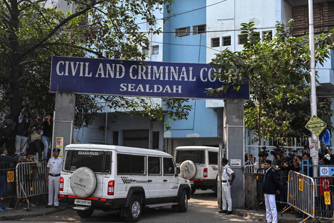Police personnel stand guard at the entrance of the Civil and Criminal Court Sealdah as the main accused of the rape and murder of an Indian doctor arrive in Kolkata on Jan. 18, 2025. (AFP)