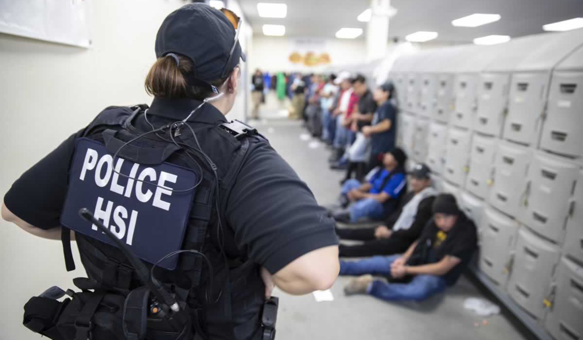 This image released by the US Immigration and Customs Enforcement (ICE) shows a Homeland Security Investigations (HSI) officer guarding suspected illegal aliens on August 7, 2019. (AFP file photo)