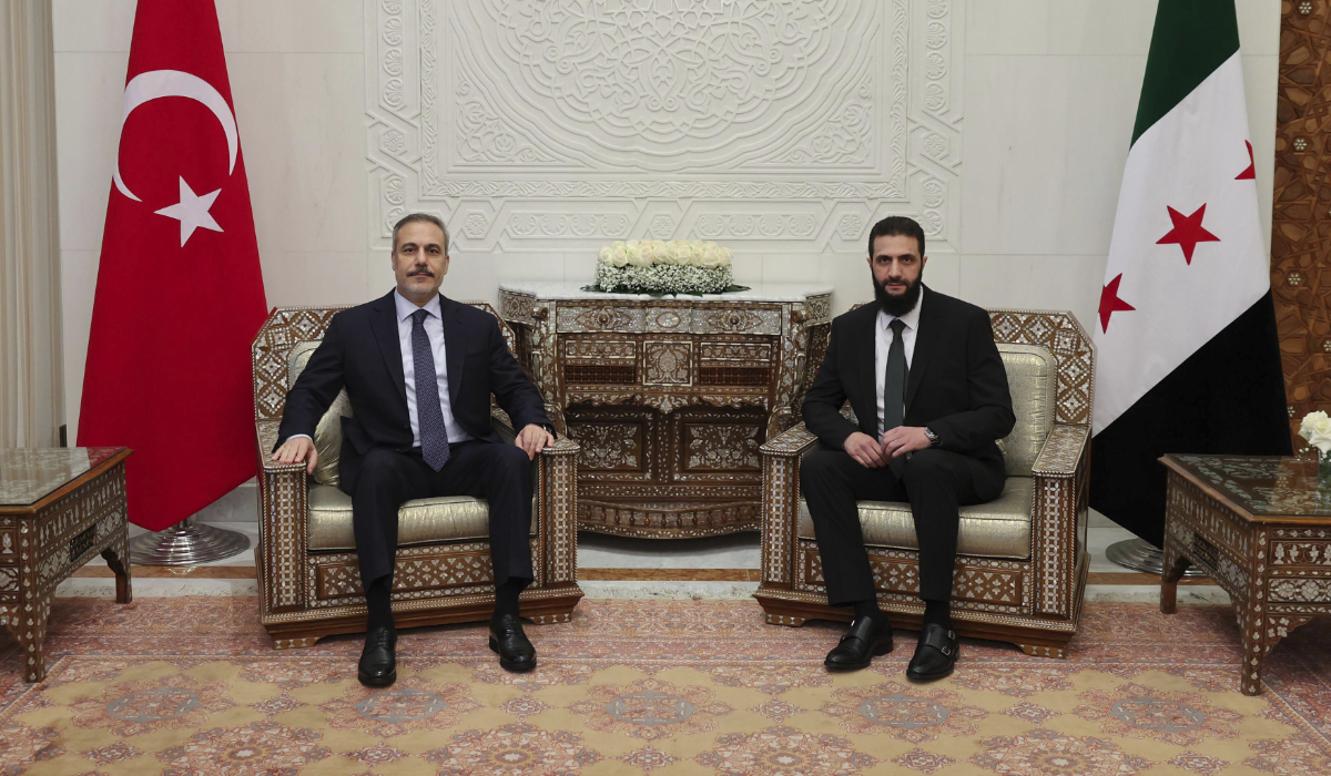 Turkish Foreign Minister Hakan Fidan, left, sits with Ahmad Al-Sharaa during their meeting in Damascus, Syria, Sunday, Dec. 22, 2024. (AP file photo)