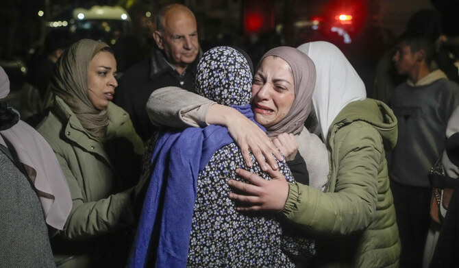 A female Palestinian prisoner is greeted after disembarking from a bus following her release from an Israeli prison, in the West Bank city of Beitunia, on Jan. 20, 2025. (AP)