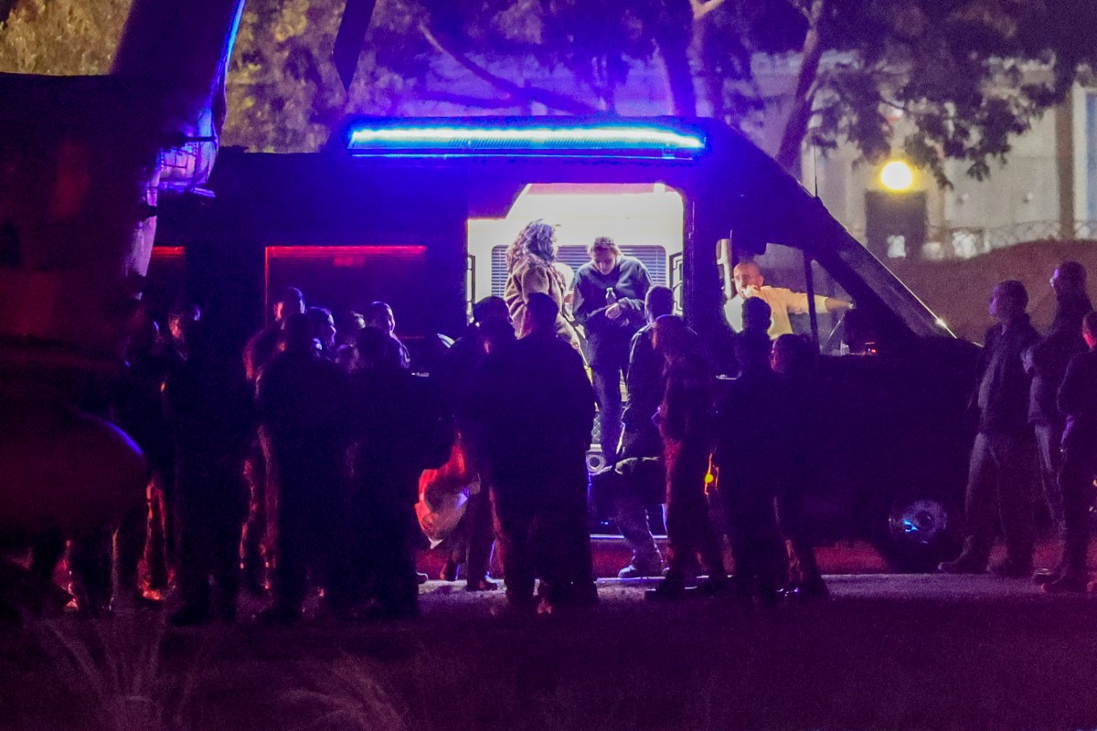 The three released Israeli hostages, who had been abducted during the October 7, 2023 attacks by Palestinian militants, exit a van before boarding an Israeli Air Force military transport helicopter near Reim in southern Israel on January 19, 2025 after a ceasefire and hostage-prisoner exchange deal in the war between Israel and Hamas was implemented. (AFP)