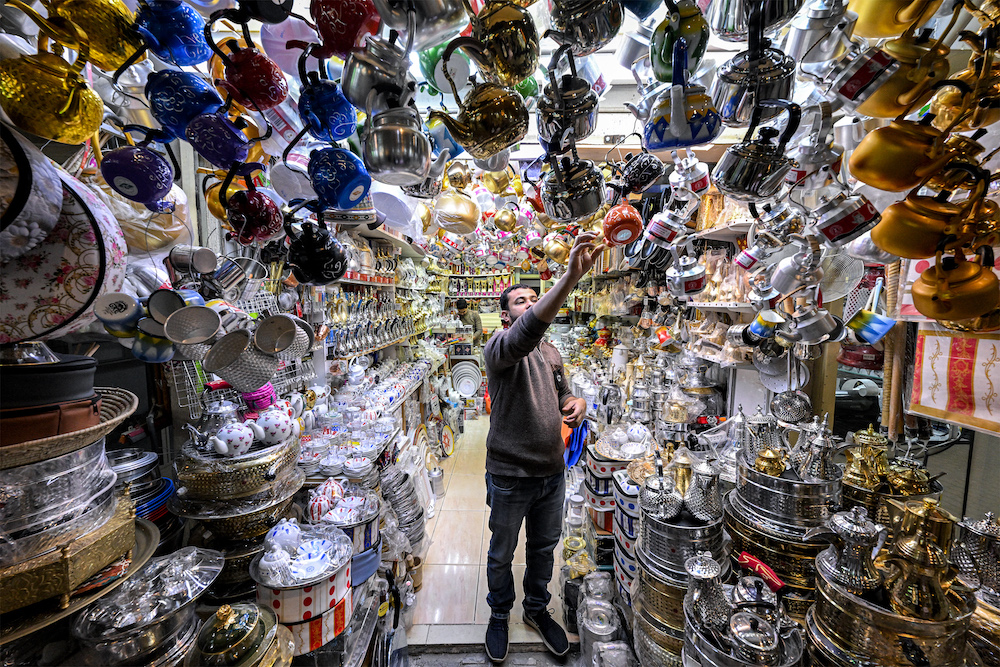 A vendor organizes traditional teapots displayed at a shop in Mubarakiya Market in central Kuwait City on Jan. 10, 2025. AFP