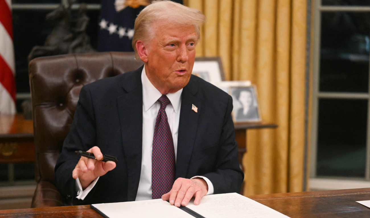 US President Donald Trump signs an executive order on the US withdrawal from WHO (World Health Organization) in the Oval Office of the White House in Washington, DC, on January 20, 2025. (AFP)