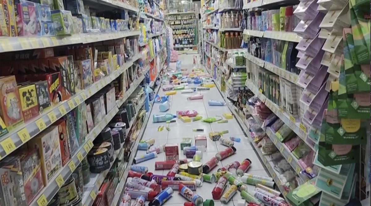 Bottles and cans are scattered on the floor at a convenience store in Tainan, Taiwan Tuesday, Jan. 21, 2025 after an earthquake. (TVBS via AP)