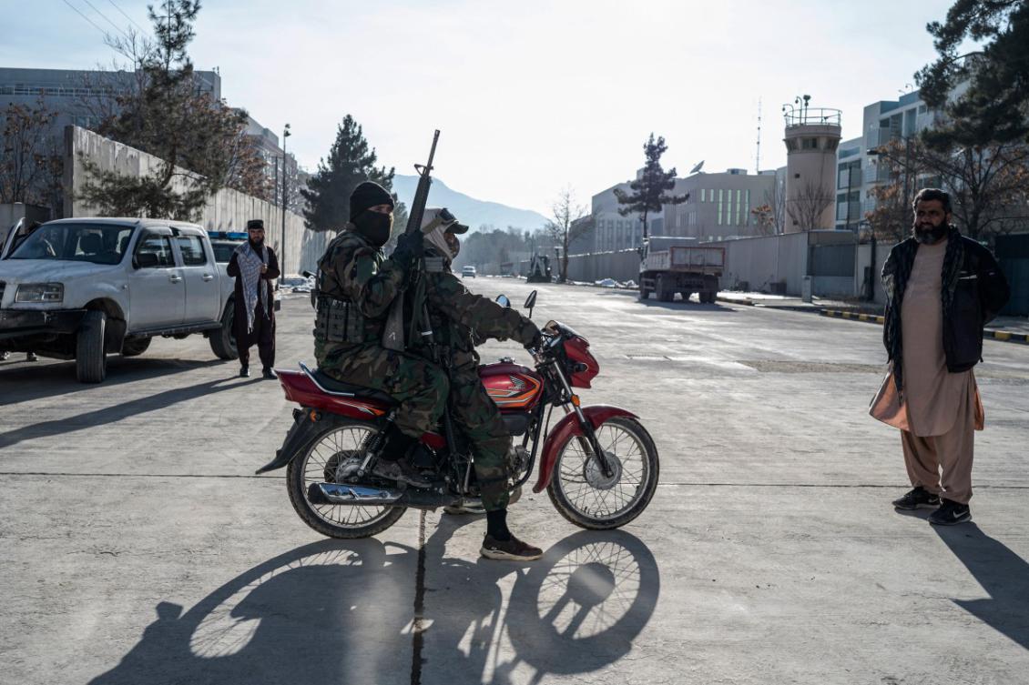 Taliban security personnel ride past the former US Embassy building in Kabul on January 12, 2025. (Photo by Wakil KOHSAR / AFP)