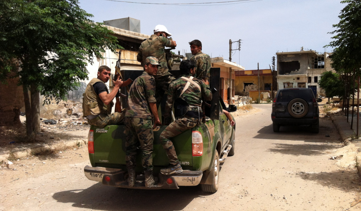 A picture taken on June 8, 2013 shows Syrian army soldiers patroling a street in the village of Buweida, north of Qusayr, in Syria's central Homs province. (AFP)