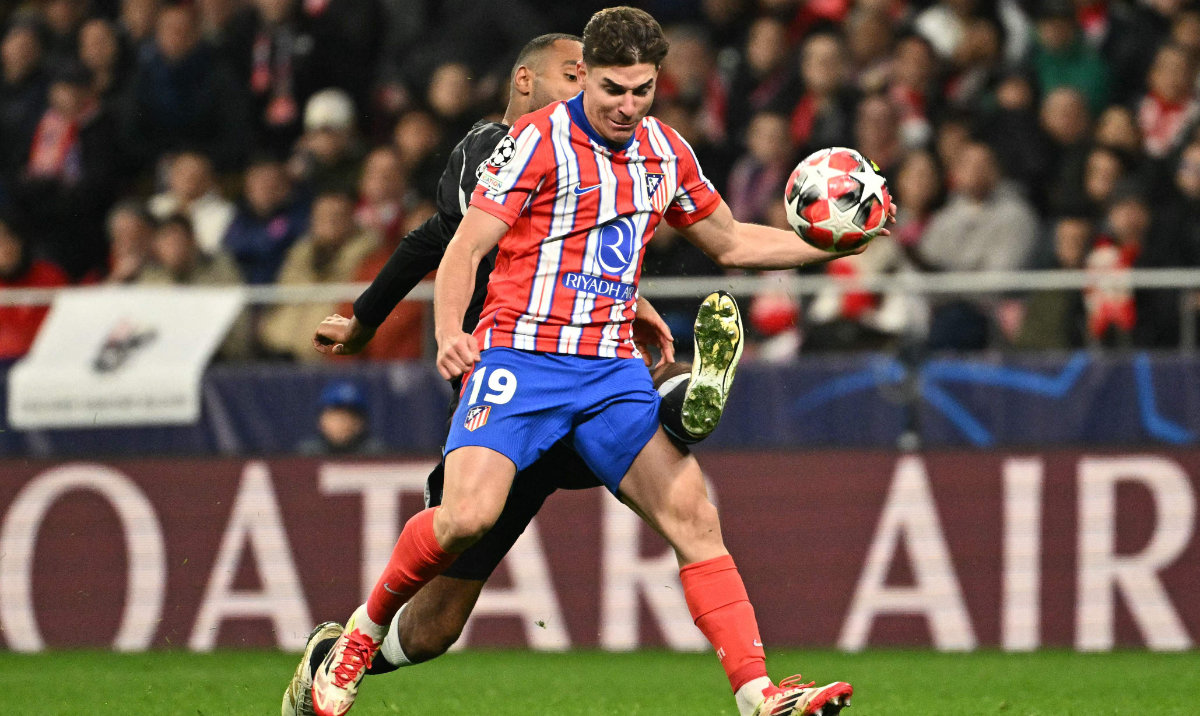 Atletico Madrid's Argentine forward #19 Julian Alvarez and Bayer Leverkusen's German defender #04 Jonathan Tah fight for the ball during the UEFA Champions League, league phase football match between Club Atletico de Madrid and Bayer Leverkusen at the Metropolitano stadium in Madrid on January 21, 2025. (AFP)