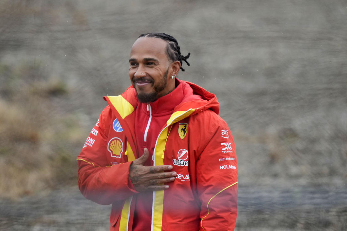 British driver Lewis Hamilton greets Ferrari fans gathered outside the track, after testing a Ferrari Formula One SF-23, in Fiorano Modenese, Italy, Jan.22, 2025. (AP)