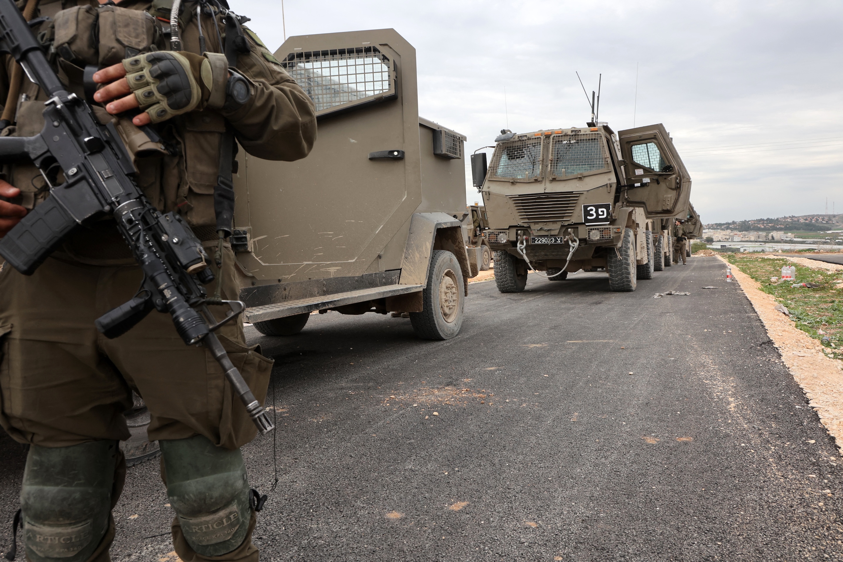 Israeli troops and military vehicles prepare to enter Jenin in the occupied West Bank, near the Israeli village of Muqeibil, Jan. 22 (AFP)