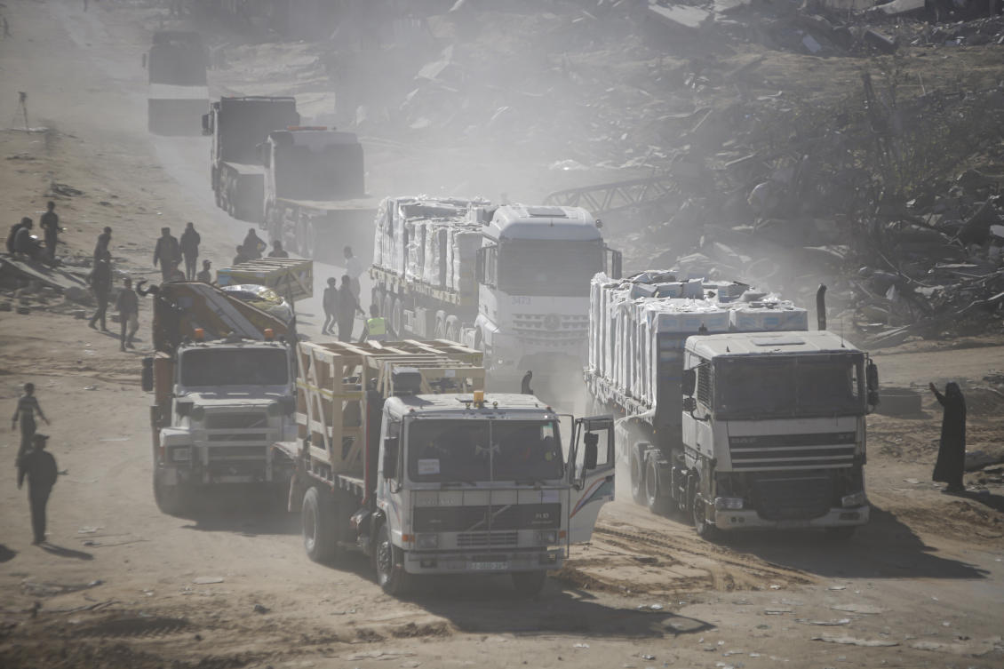 Humanitarian aid trucks enter through the Kerem Shalom crossing from Egypt into the Gaza Strip. (AP)