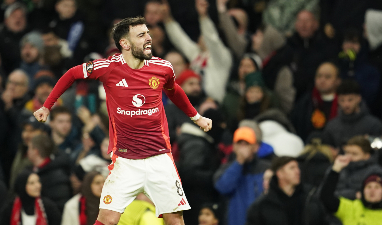 Manchester United’s Bruno Fernandes celebrates after scoring his side’s second goal during the Europa League opening phase soccer match between Manchester United and Glasgow Rangers in Manchester, England, Thursday. (AP)
