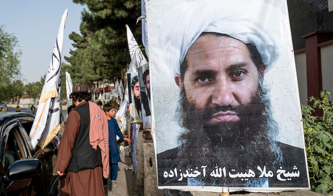 A poster of Taliban Supreme Leader Hibatullah Akhundzada is seen along a road in Kabul on August 14, 2023. (AFP/File)