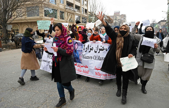 Afghan women march as they chant slogans and hold banners during a women’s rights protest in Kabul on January 16, 2022. (AFP/File)