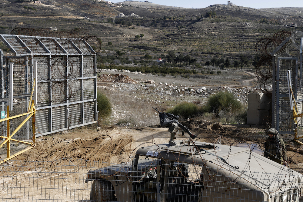 An Israeli army vehicle patrols near the fence leading into the UN-patrolled buffer zone, which separates Israeli and Syrian forces in the Golan Heights on Jan. 5, 2025. (AFP)