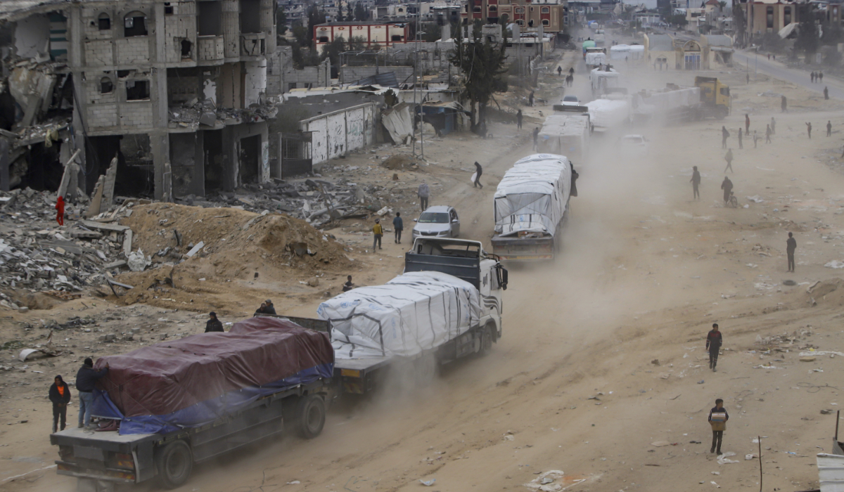Humanitarian aid trucks enter through the Kerem Shalom crossing from Egypt into the Gaza Strip, in Rafah, Wednesday, Jan. 22, 2025, days after the ceasefire deal between Israel and Hamas came into effect. (AP)