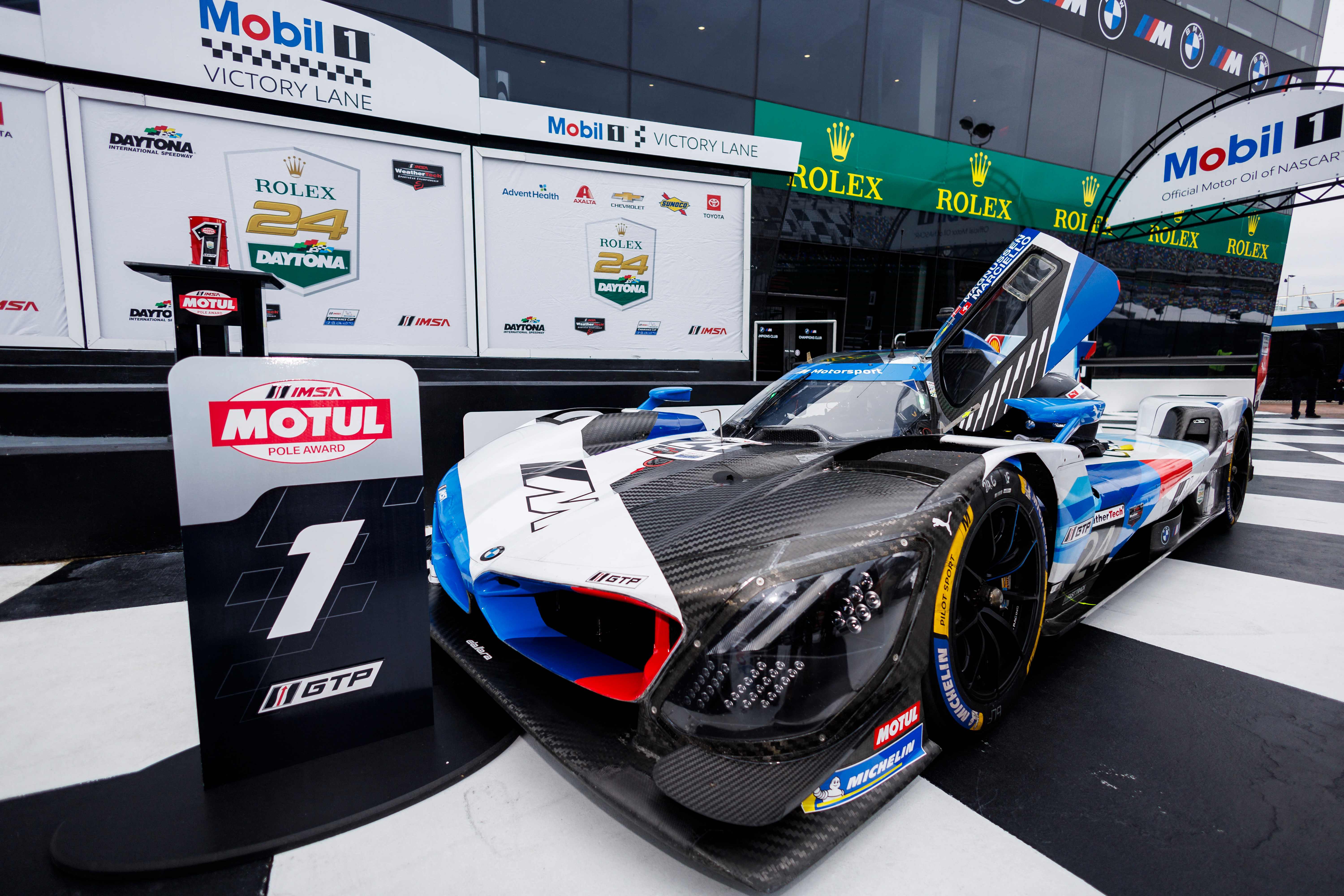 The BMW M Team RLL BMW M Hybrid V8 of Philipp Eng, Kevin Magnussen, Raffaele Marciello, and Dries Vanthoor sits in victory lane after winning the pole award during qualifying for the Rolex 24 at Daytona International Speedway in Daytona Beach, Florida. (Getty Images via AFP)