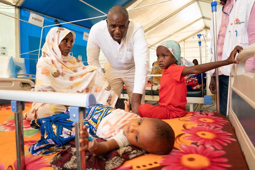 Britain’s Foreign Secretary David Lammy, center, meets with patients in a malnutrition center near the Chad border with South Sudan on Jan. 24, 2025. (AFP)