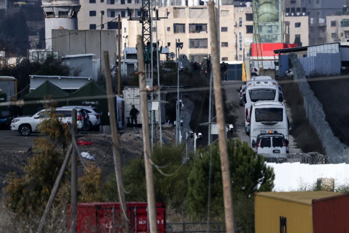 Buses transporting Israeli prisoners leave the Ofer military prison, located between Ramallah and Beitunia in the occupied West Bank, on Jan, 25. Israel is set to free 200 Palestinian prisoners in exchange for four Israeli women hostages in second swap. (AFP)