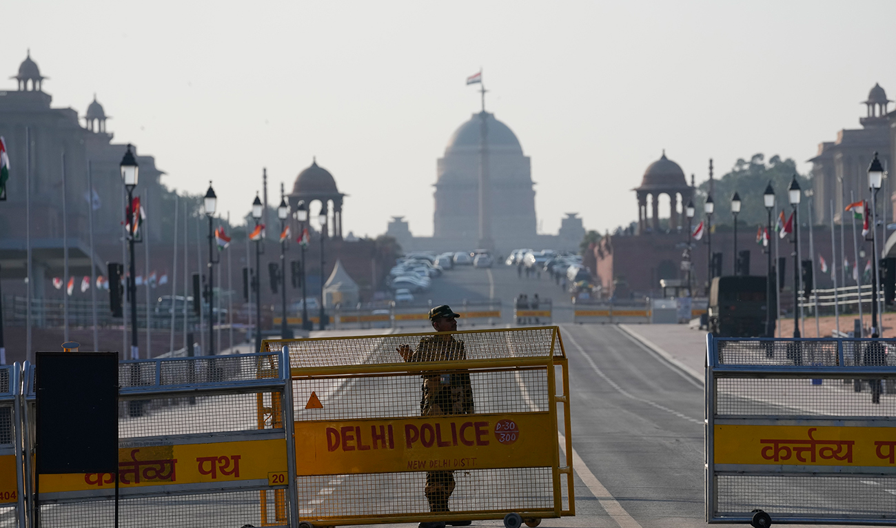 An Indian paramilitary soldier stands guard near a police barricade on Kartavya Path in New Delhi on January 23, 2025. (AP)