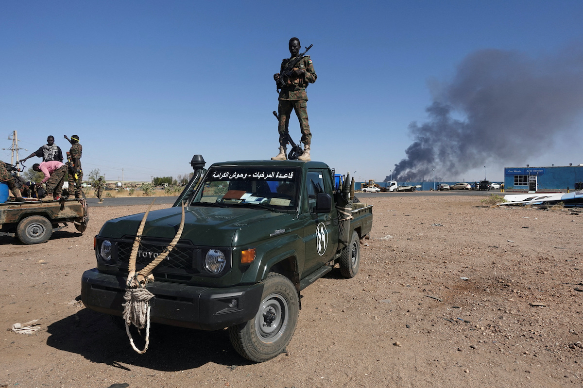 Sudan army soldiers celebrate the retaking an oil refinery in North Bahri on Saturday. (Reuters)