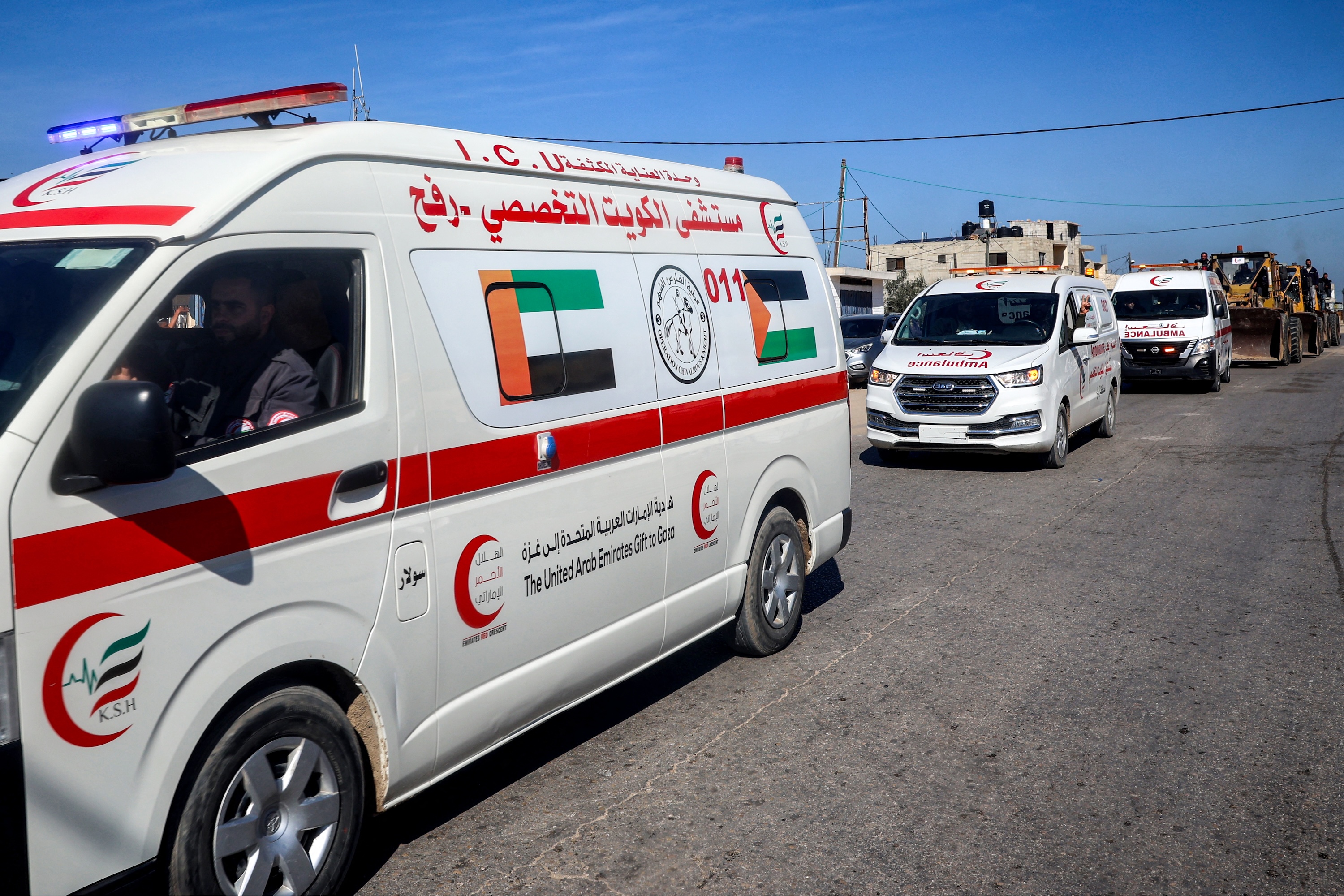 Ambulances and bulldozers move along a road in Rafah in the southern Gaza Strip, Jan. 21 (AFP)