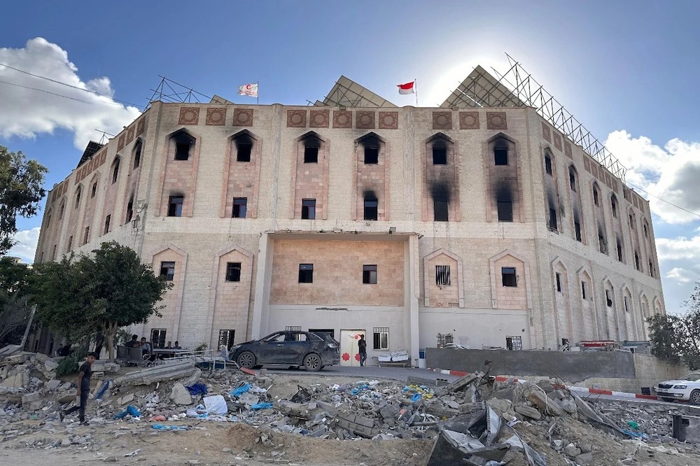 People stand near the Indonesia Hospital in Beit Lahiya in this photo shared on October 2024. (MER-C)