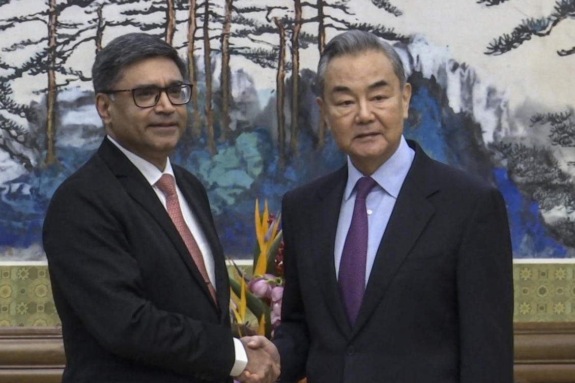 In this image taken from video footage run by Phoenix TV, Chinese Foreign Minister Wang Yi, right, meets with India's Foreign Secretary Vikram Misri in Beijing, Monday, Jan. 27, 2025. (APTN)