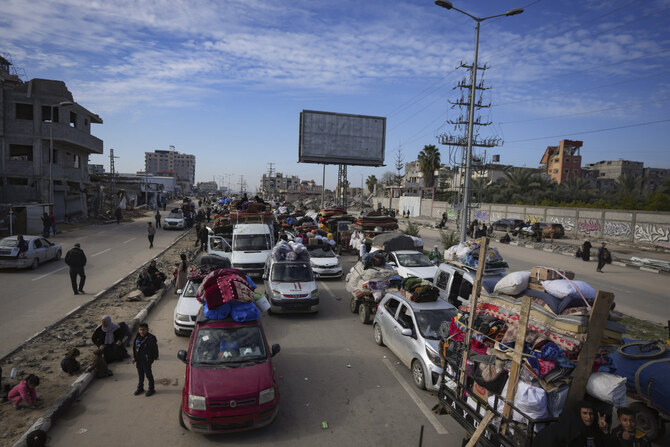 Displaced Palestinians with their belongings gather near a roadblock on Salah Al-Din Street as they wait to return to their homes in the northern part of the Gaza Strip on January 26, 2025. (AP)