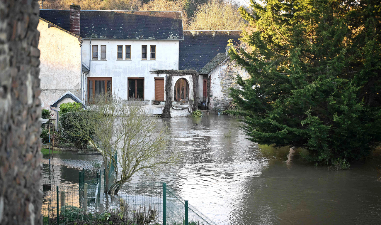 Gardens and streets are submerged in flood water following Storm Hermina, in Caumont-sur-Oren, northwestern France, on Monday. (AFP)
