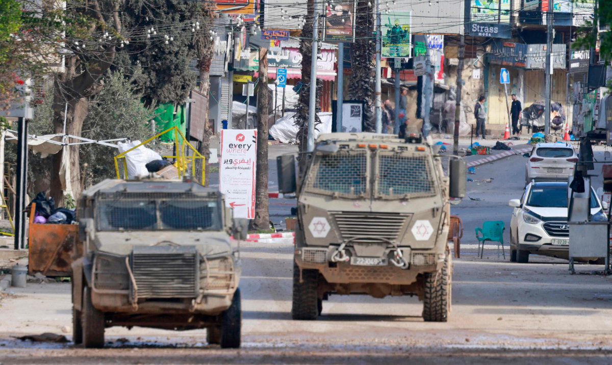 Israeli military vehicles drive during a raid inside the Jenin camp for Palestinian refugees on January 25, 2025. (AFP)