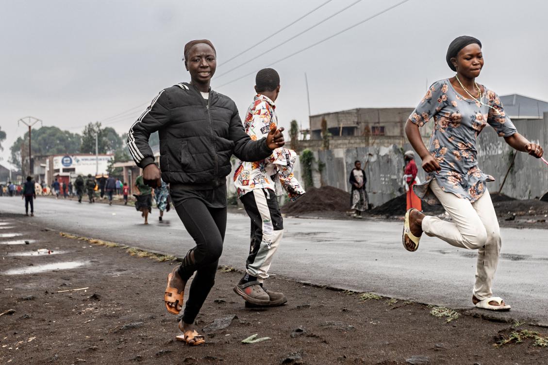 Residents run off after observing members of the M23 armed group walking through a street of the Keshero neighborhood in Goma on Jan. 27, 2025. (AFP)