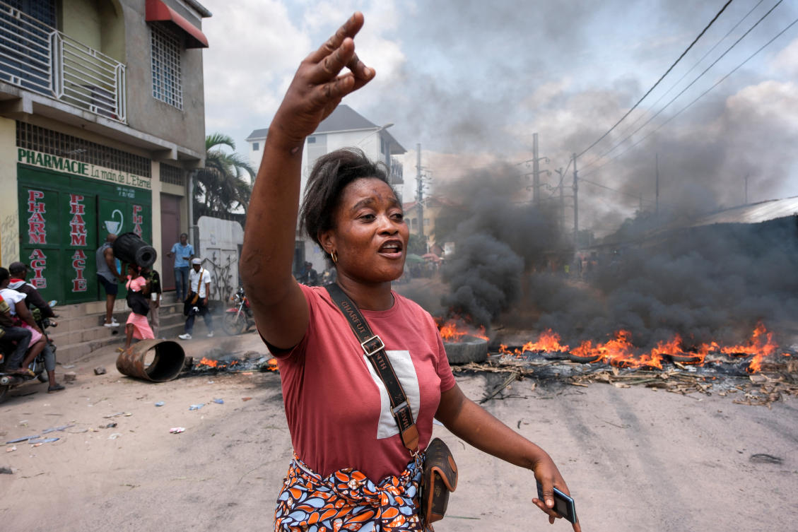 A protester gestures, while tires and other objects burn, during a demostration in Kinshasa, Democratic Republic of Congo, January 28, 2025.(Reuters)