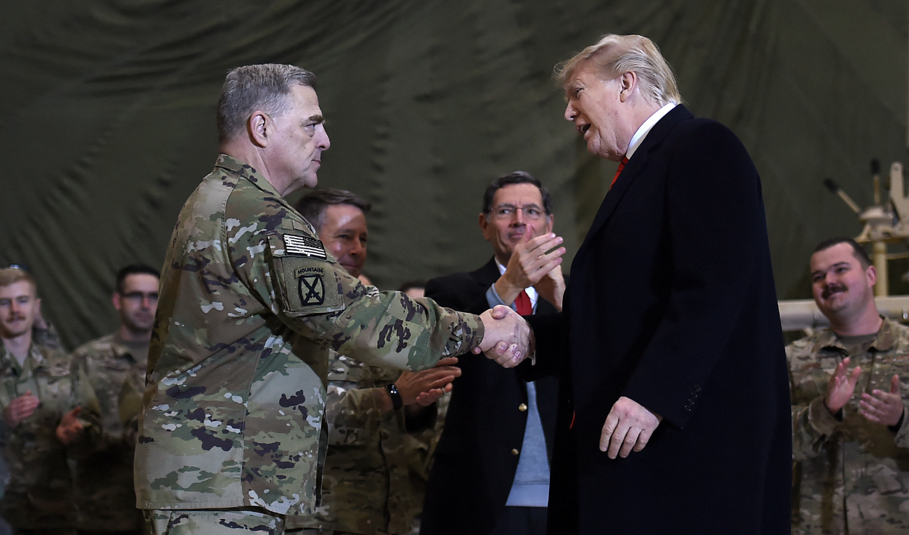 US President Donald Trump shakes hands with Mark Milley before addressing the troops at Bagram Air Field during a surprise Thanksgiving day visit, on November 28, 2019 in Afghanistan. (AFP/File)