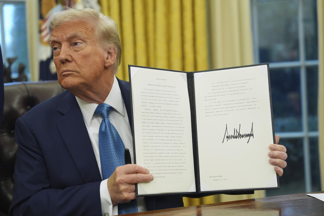 President Donald Trump holds a signed executive order on deregulation in the Oval Office of the White House, Jan. 31, 2025, in Washington. (AP)