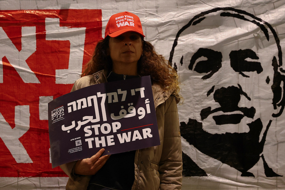 A protester holds a placard during a protest against the government and to show support for the hostages. (Reuters)